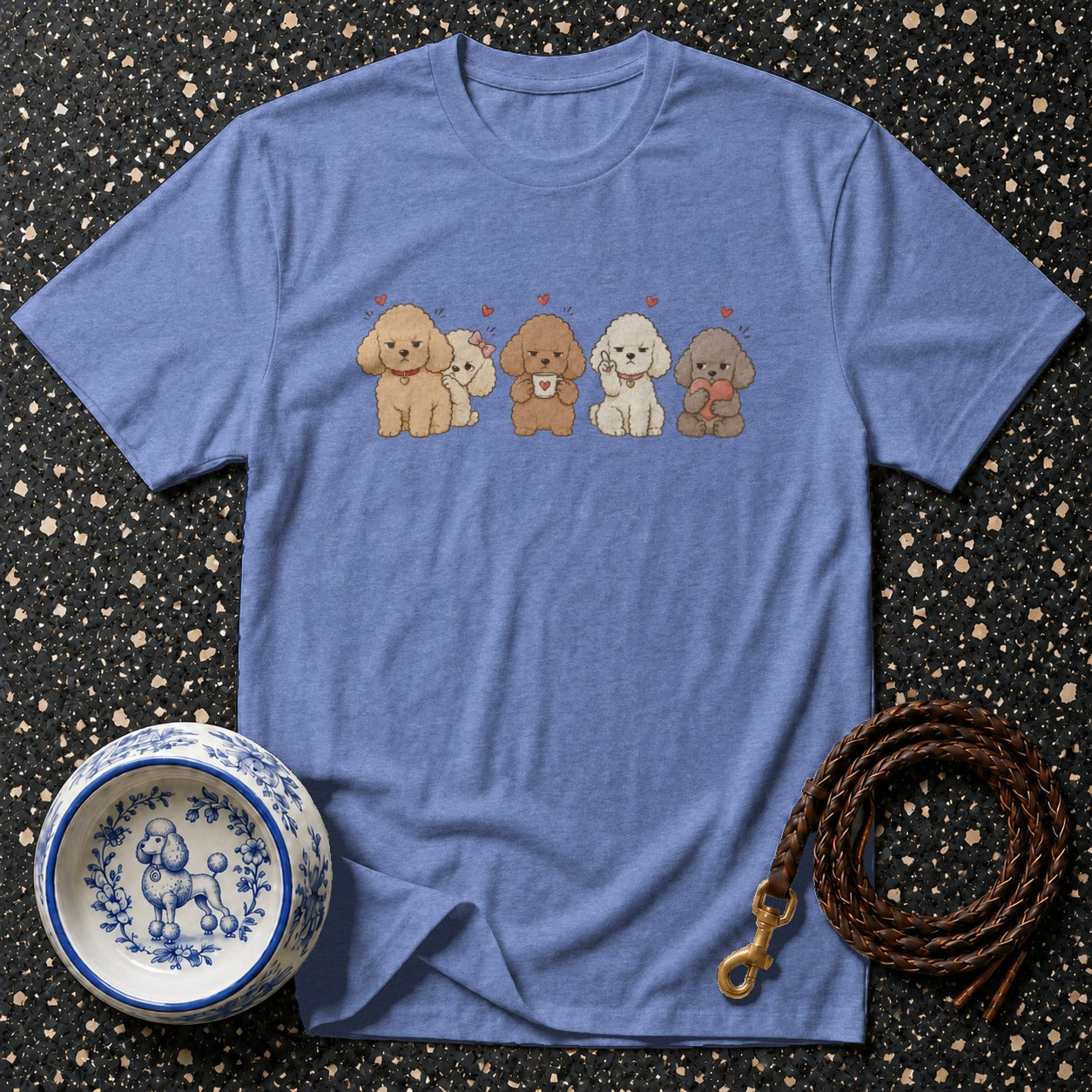 Blue t-shirt with illustration of five poodles, a dog bowl, and a leash.