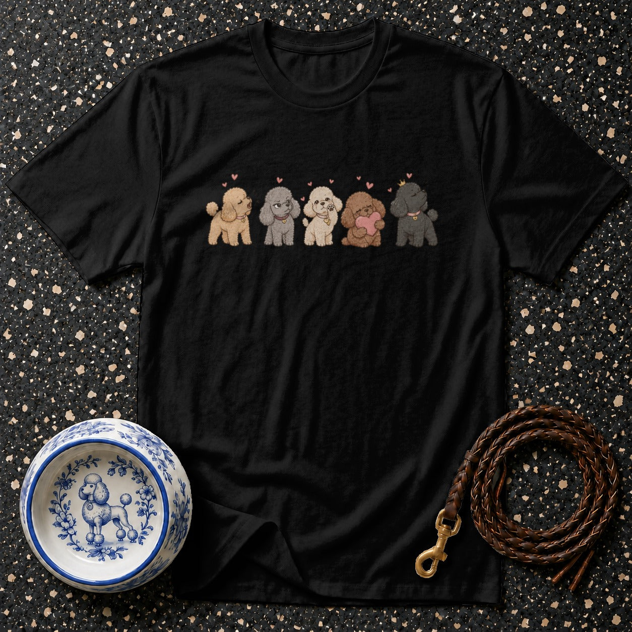 Black t-shirt with a drawing of five poodles in different colors and pink hearts.