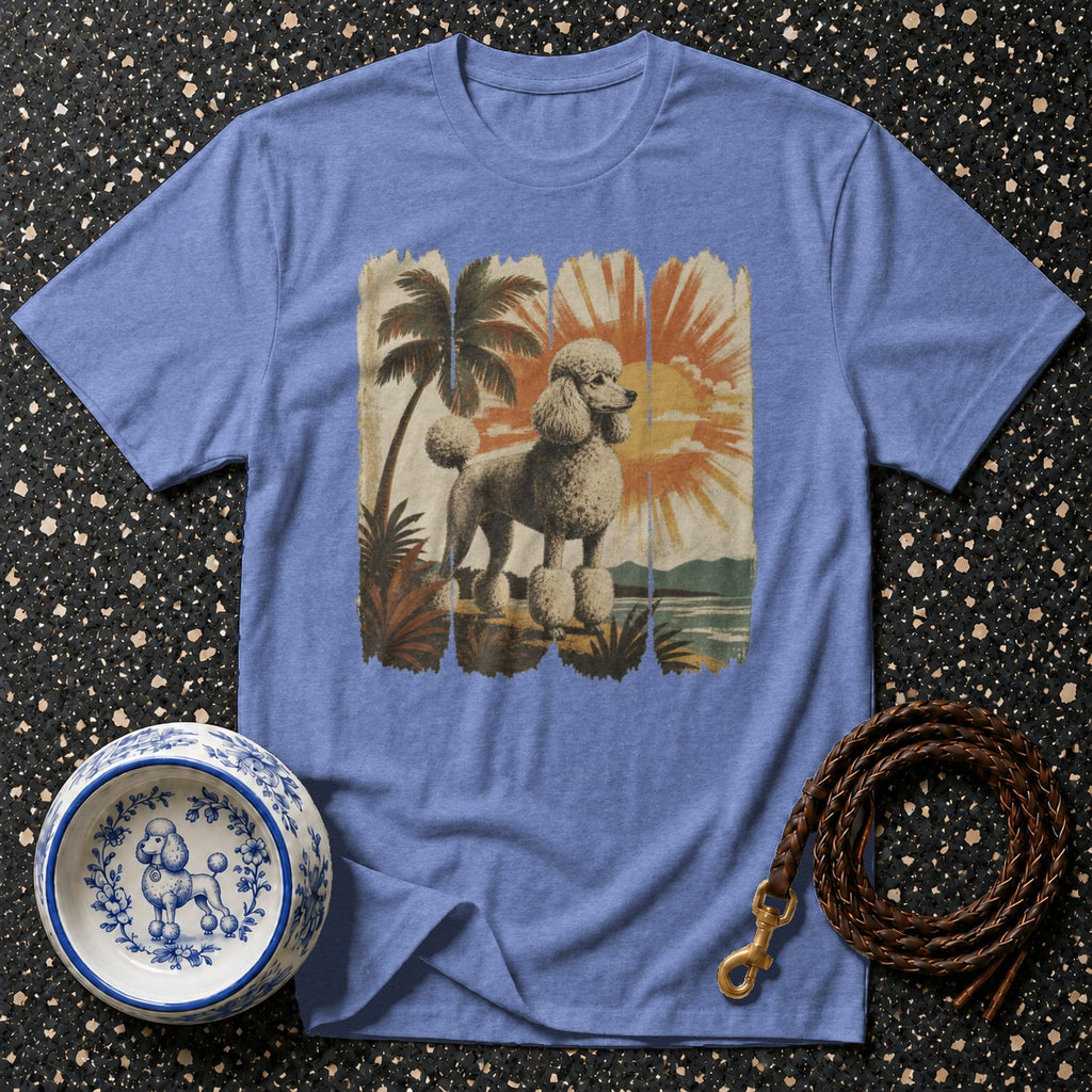 Blue t-shirt with a distressed graphic of a poodle on a tropical beach at sunset.
