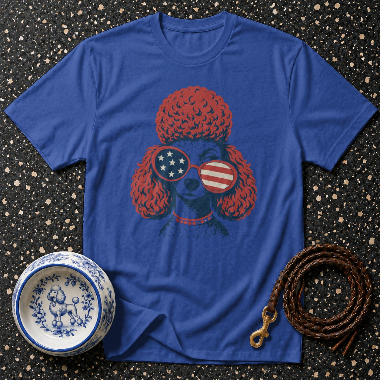 Blue t-shirt with a stylized poodle wearing patriotic sunglasses and a red collar.
