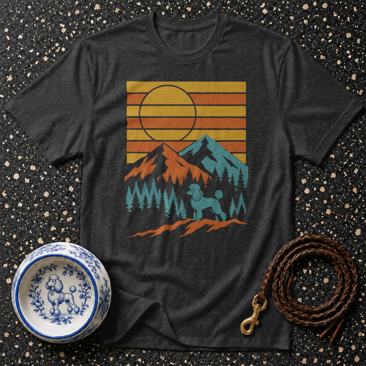 Dark t-shirt with a retro mountain and poodle graphic and a dog bowl and leash.