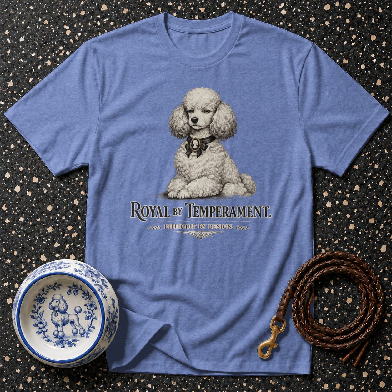 Blue t-shirt with a white poodle illustration and text "ROYAL BY TEMPERAMENT."