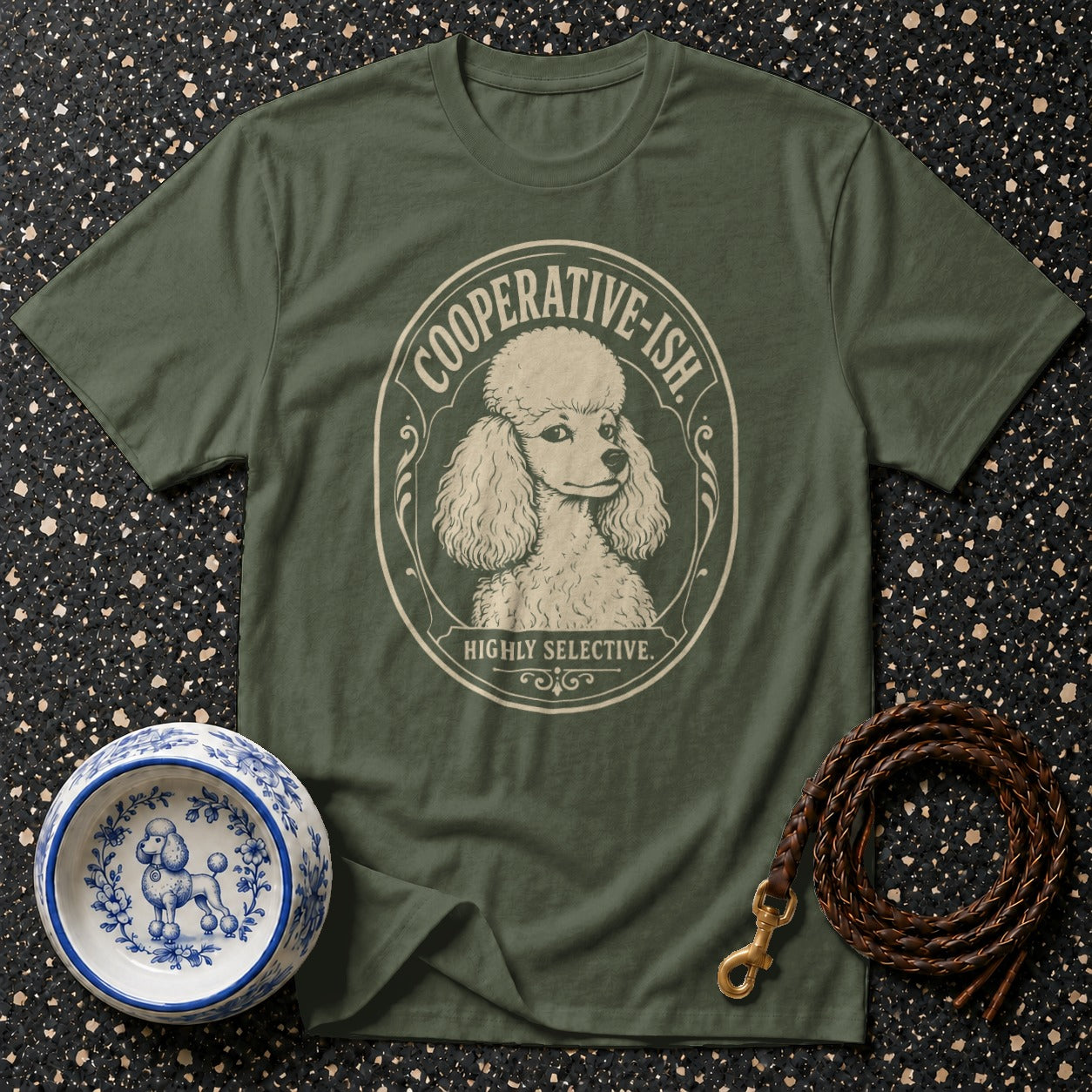 Green t-shirt with a poodle graphic saying "COOPERATIVE-ISH. HIGHLY SELECTIVE."