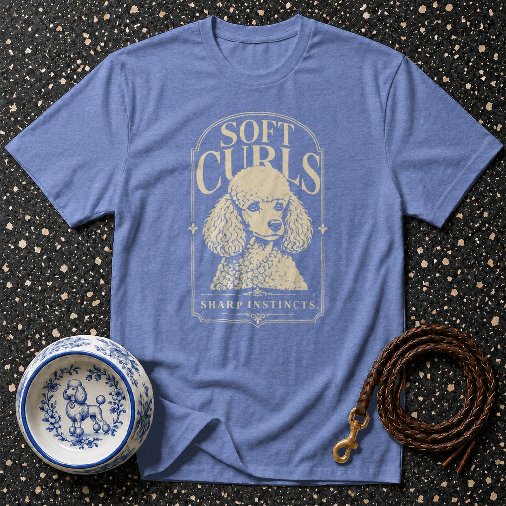 Blue t-shirt with a poodle graphic and text "SOFT CURLS SHARP INSTINCTS".