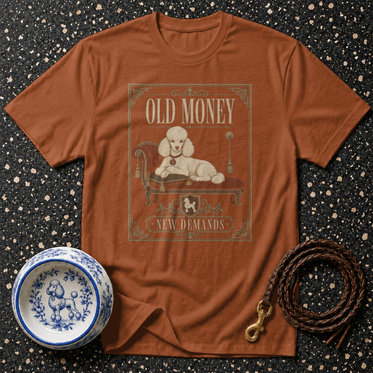 Orange t-shirt with "Old Money New Demands" text and a reclining poodle graphic.
