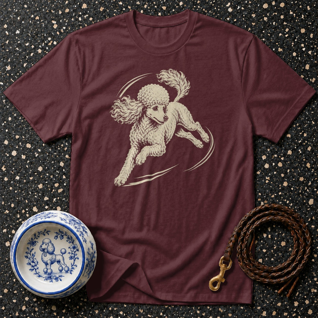 Maroon t-shirt with cream poodle graphic, white and blue patterned dog bowl, and leather leash.
