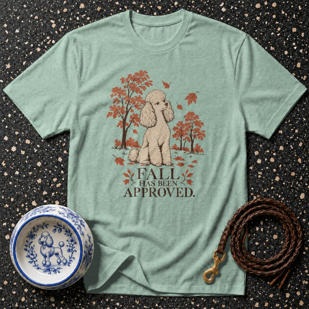 Light blue t-shirt with a poodle and autumn trees graphic.