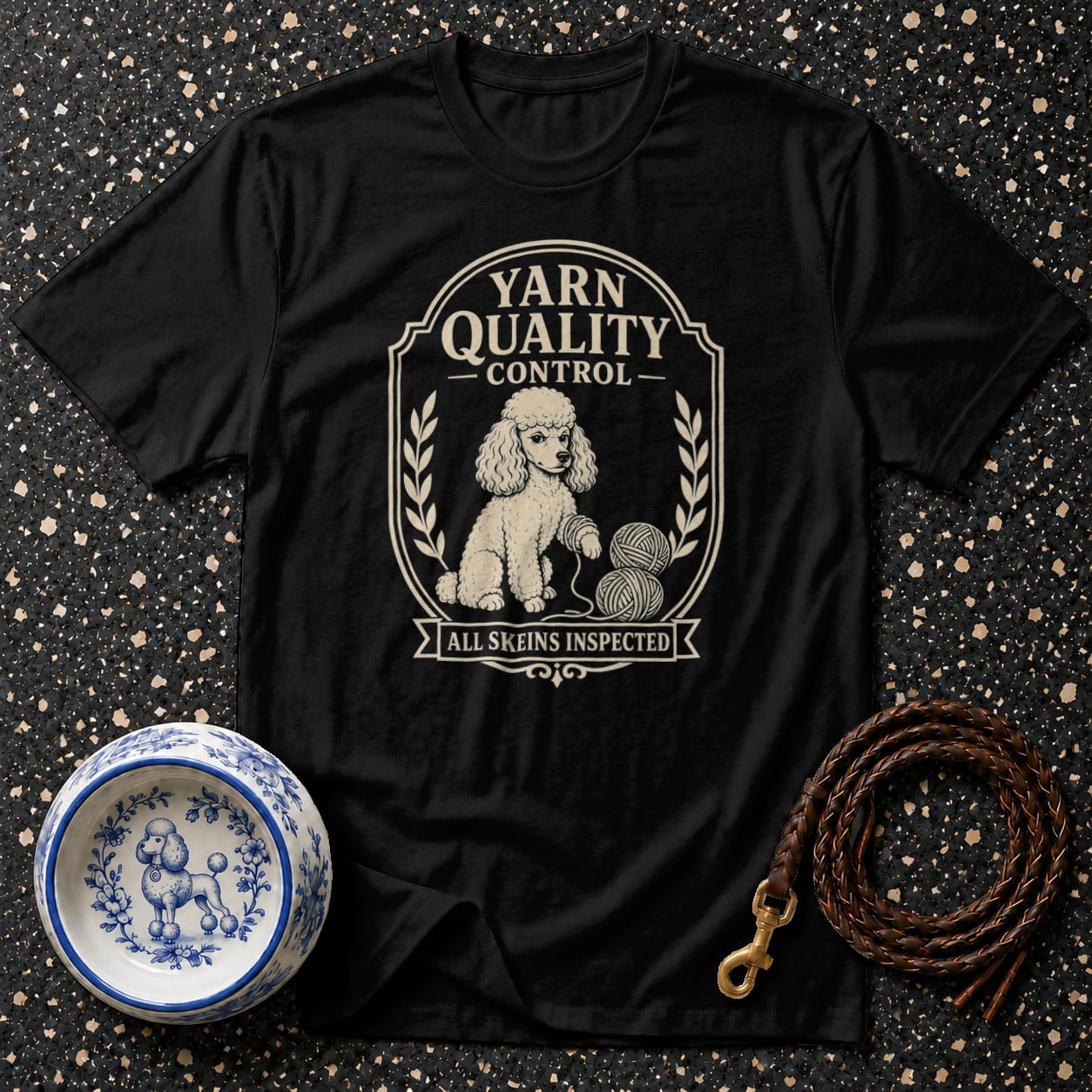 Black t-shirt with a poodle and yarn graphic reading "Yarn Quality Control".