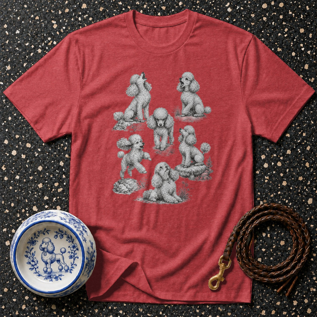 Red t-shirt with a sketch of seven poodles, a blue and white dog bowl, and a leather leash.