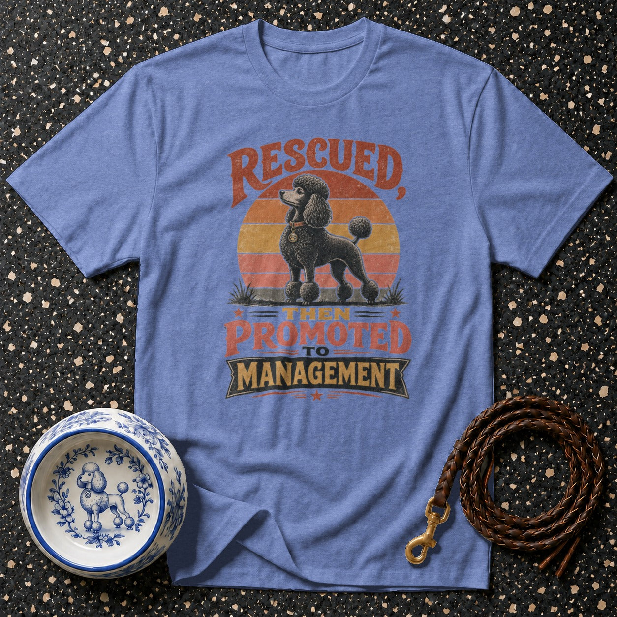Blue t-shirt with a poodle graphic and text "RESCUED THEN PROMOTED TO MANAGEMENT".