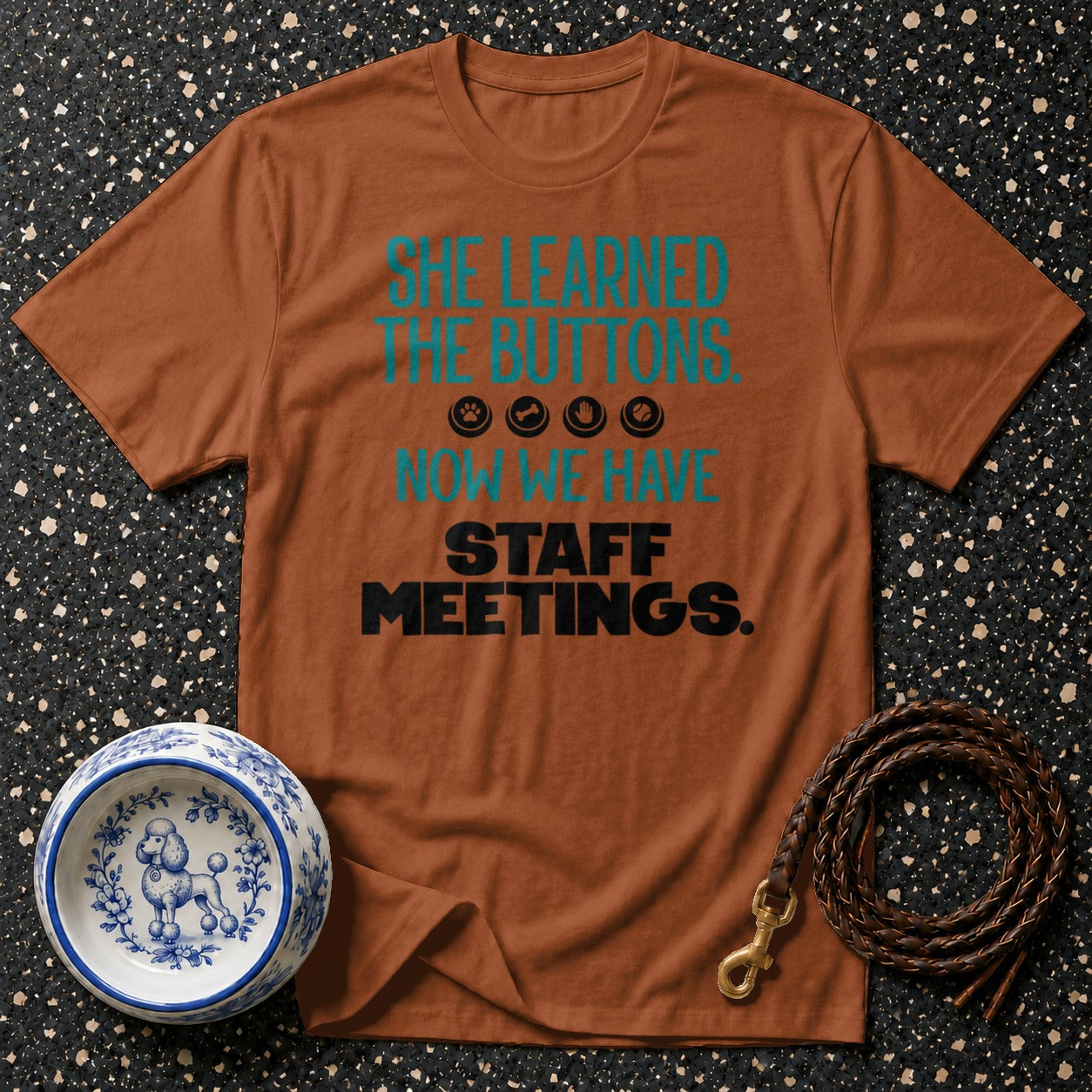 Brown t-shirt with "She Learned The Buttons. Now We Have Staff Meetings." text.