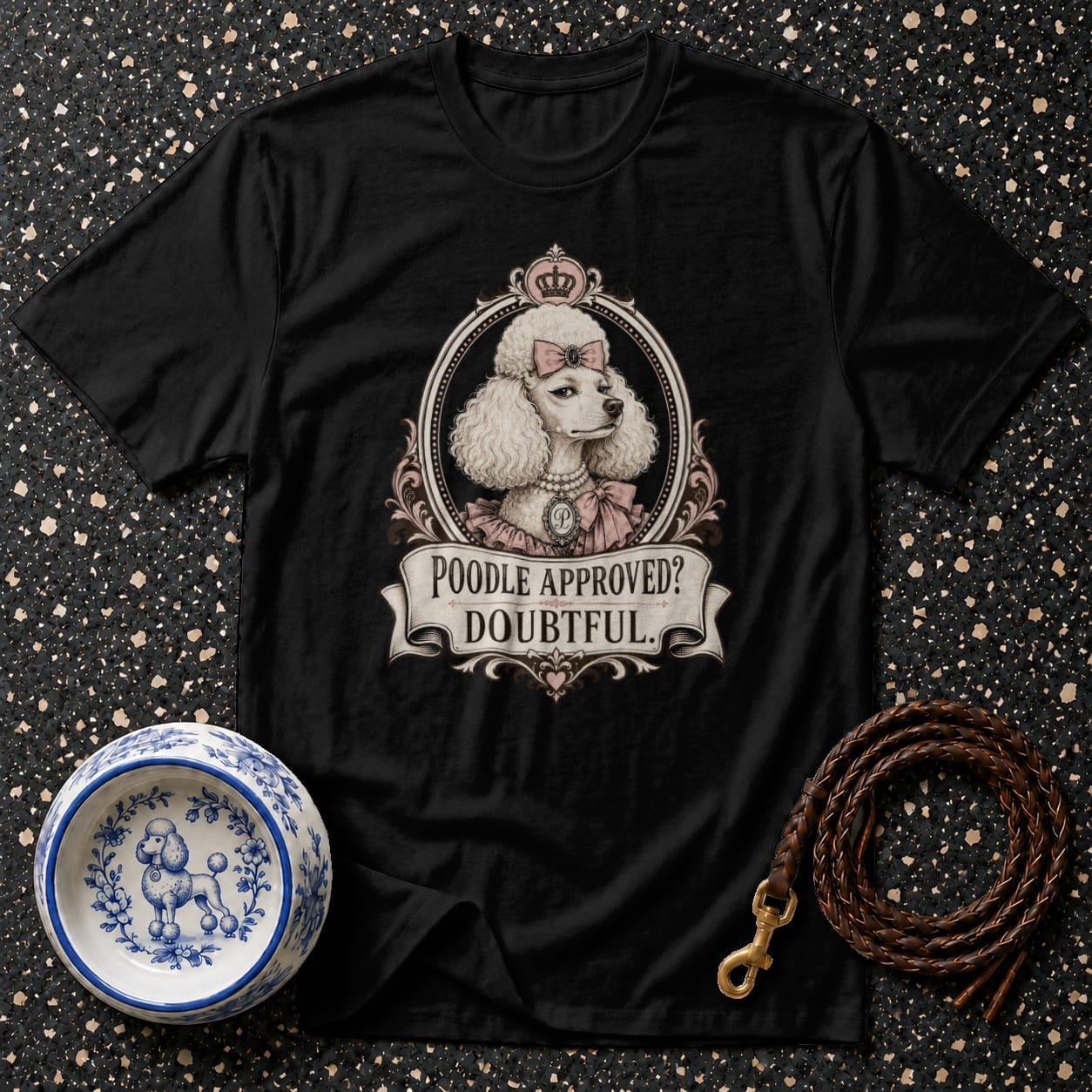 Black t-shirt graphic of a poodle wearing a crown and bow, with text "Poodle Approved? Doubtful."