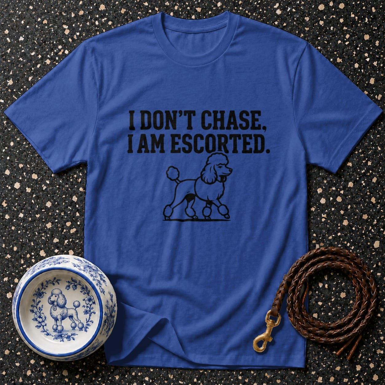 Blue t-shirt with "I DON'T CHASE, I AM ESCORTED" text and poodle illustration.