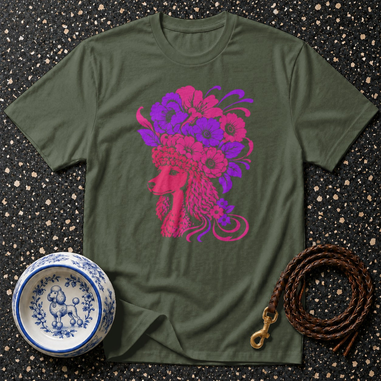 Olive green t-shirt with a vibrant pink and purple poodle and floral graphic.