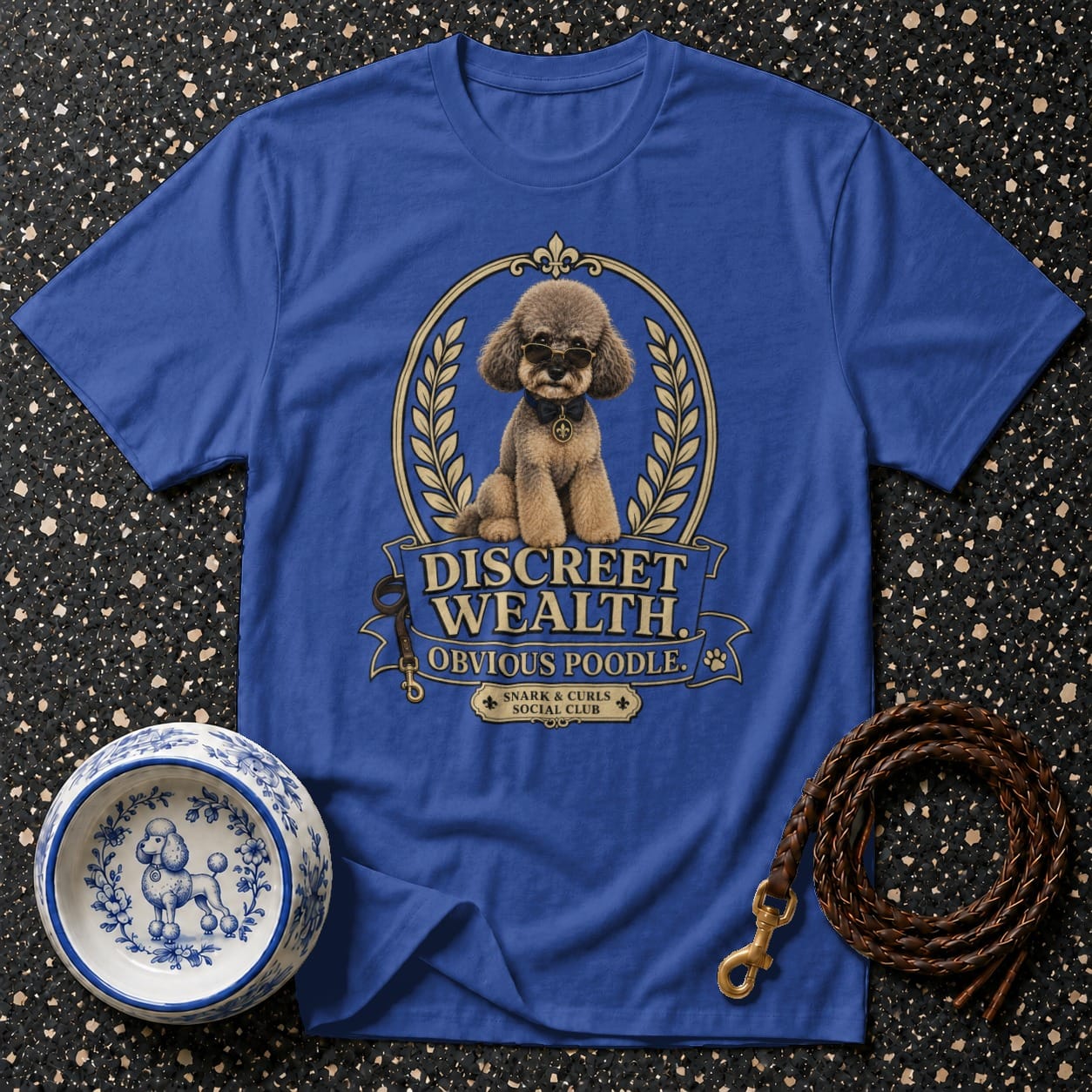 Blue t-shirt with "Discreet Wealth Obvious Poodle" graphic and a poodle.