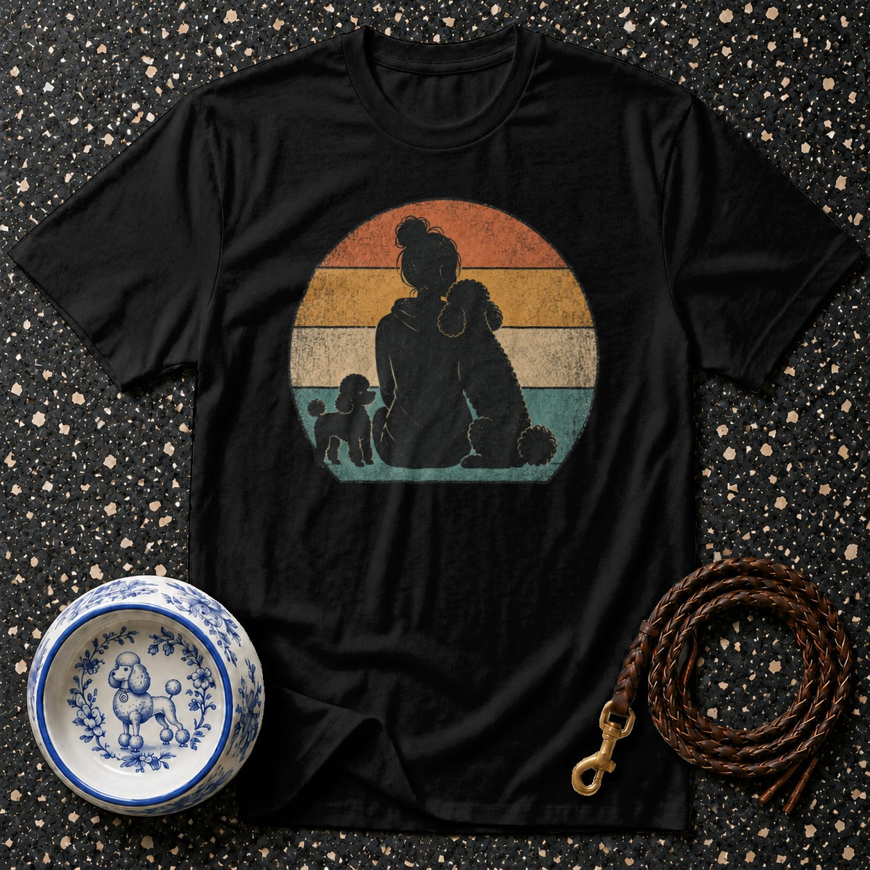 Black t-shirt with vintage sunset graphic of woman and three poodles.