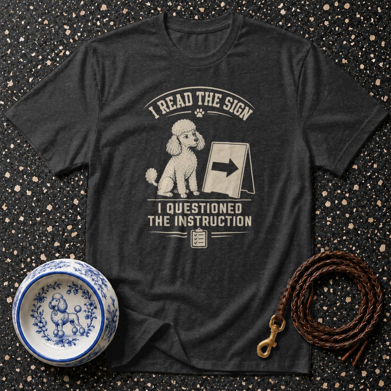 Dark t-shirt with poodle graphic and text "I READ THE SIGN I QUESTIONED THE INSTRUCTION".