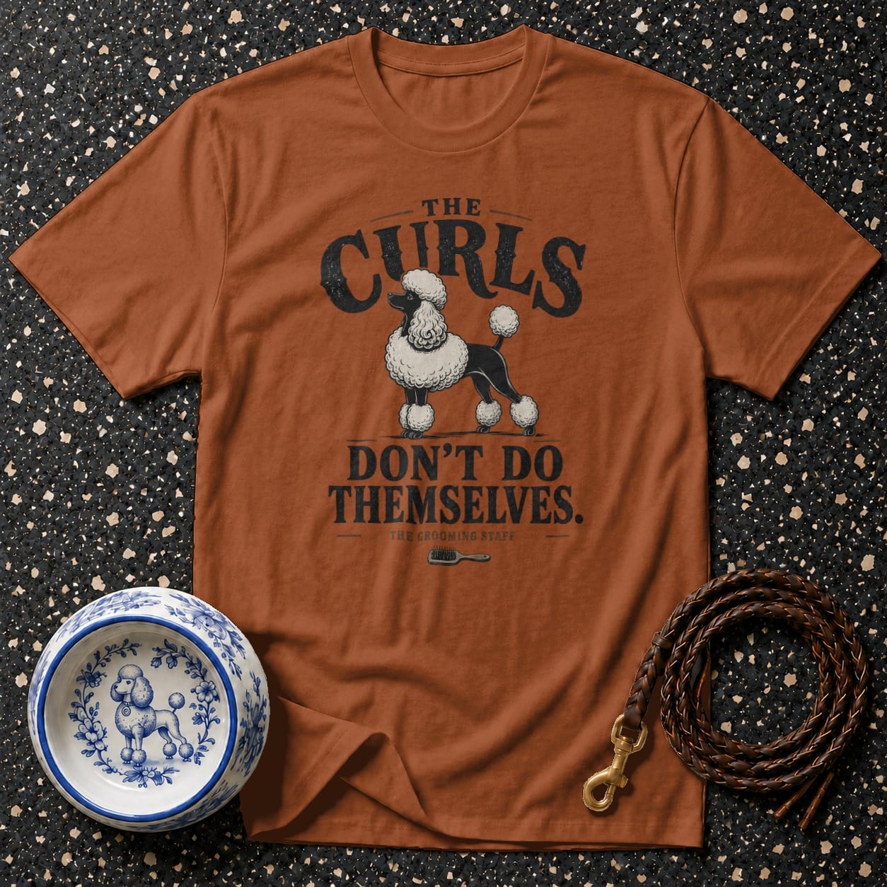 Brown t-shirt with poodle graphic and text "The Curls Don't Do Themselves."