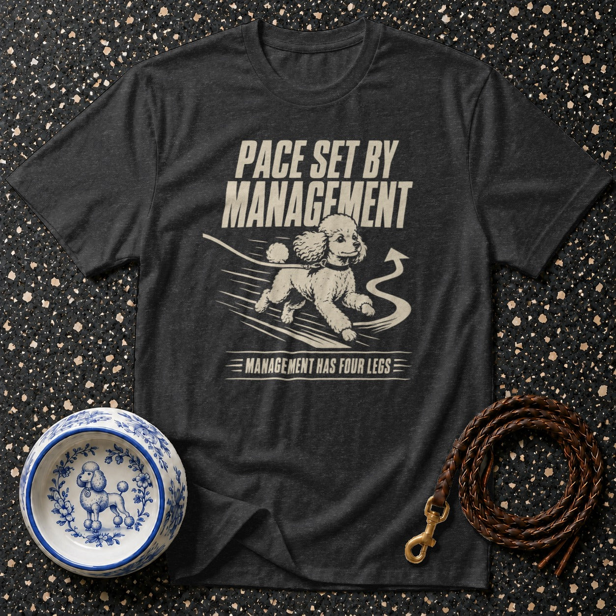 Dark grey t-shirt with a graphic of a running poodle and text "Pace set by management."
