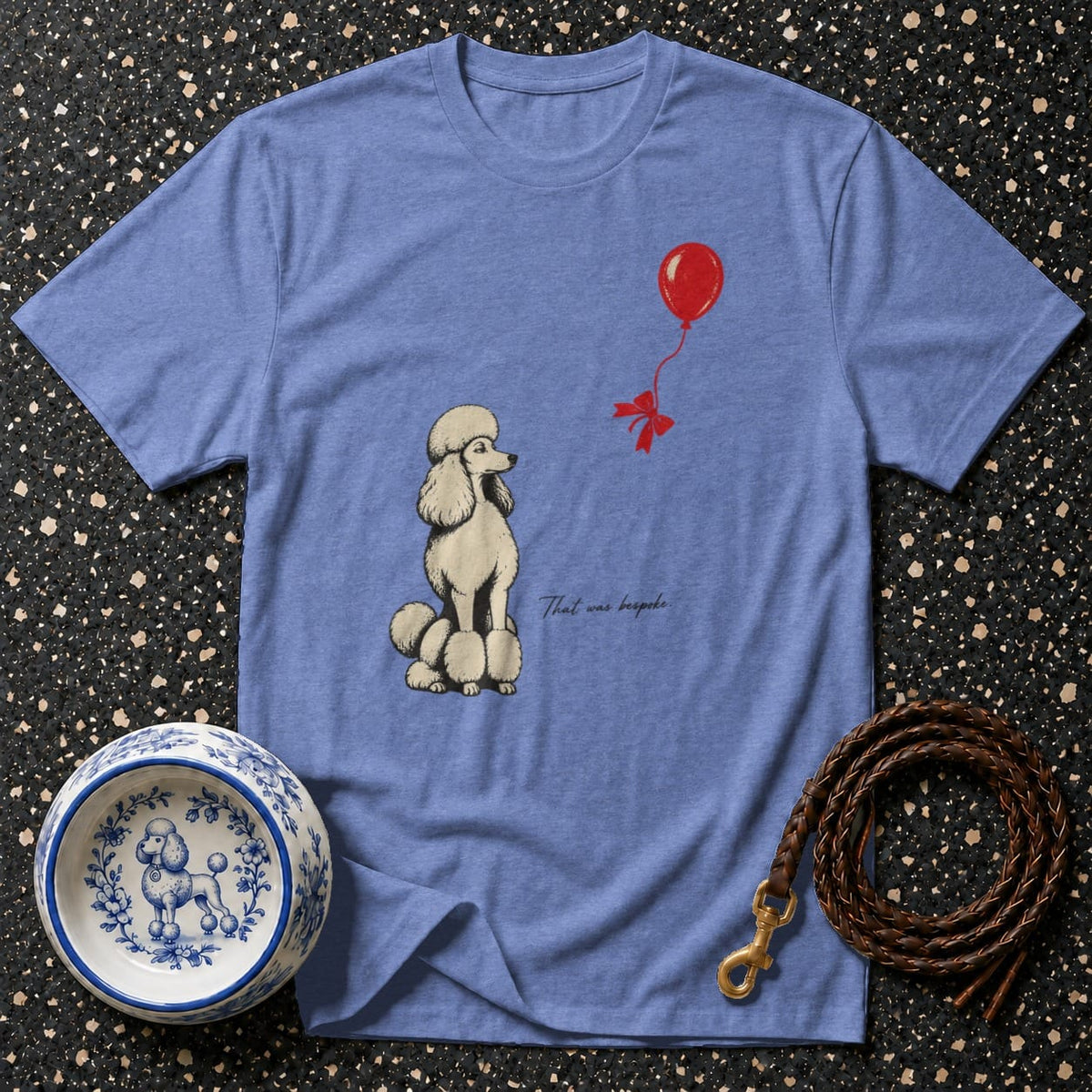 T-shirt with a cream poodle illustration and red balloon, with text "That was bespoke."