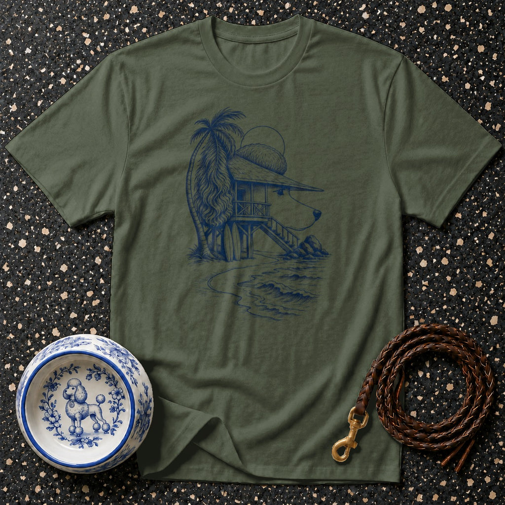 Green t-shirt with a blue line drawing of a dog house on a beach and a poodle in a bowl.