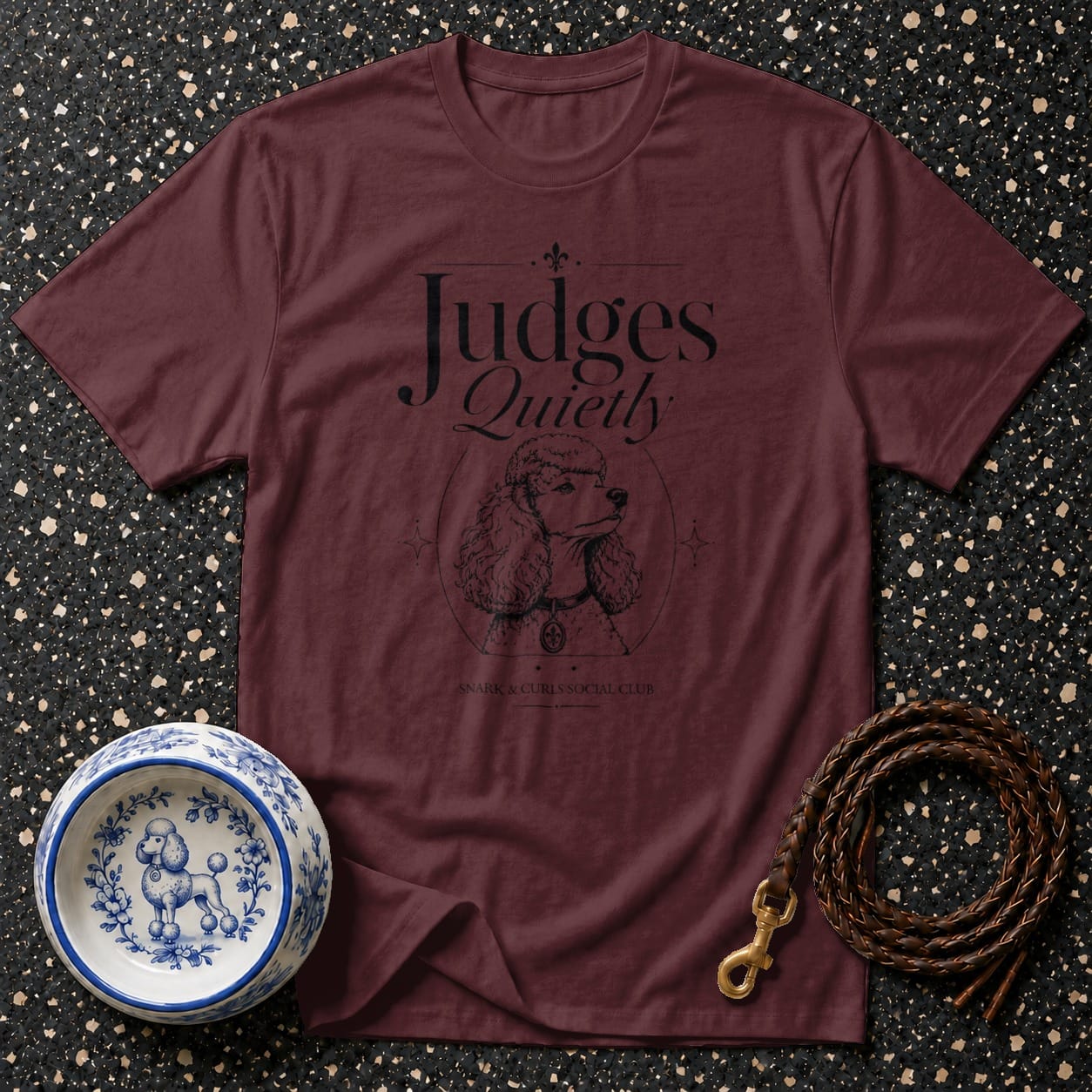 Maroon t-shirt with "Judges Quietly" text and poodle illustration.