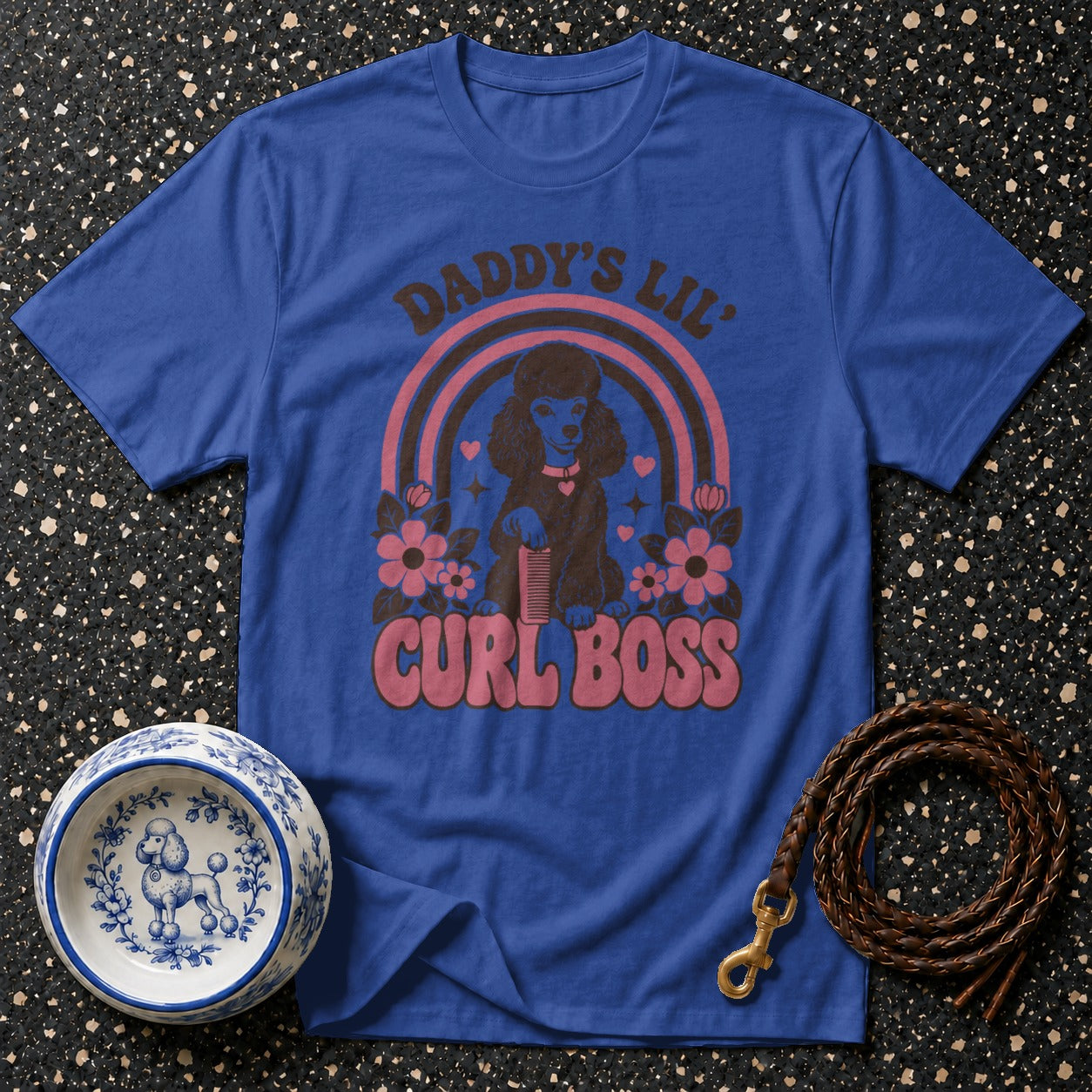Blue t-shirt with "Daddy's Lil' Curl Boss" text, poodle, rainbow, and flowers graphic.