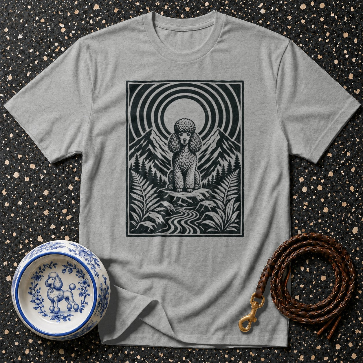 Grey t-shirt featuring a black and white graphic of a poodle in a mountain landscape.