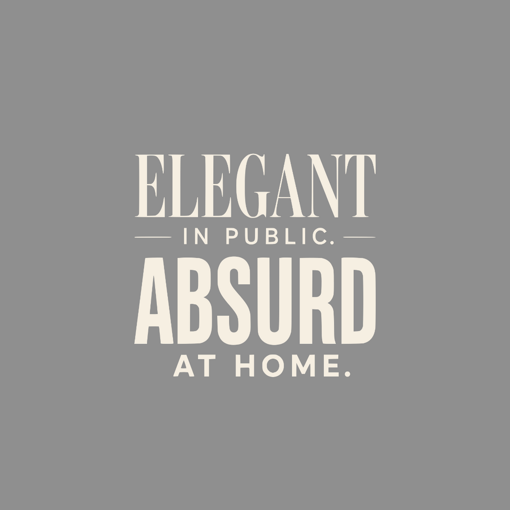 Elegant in public, absurd at home text on a gray background.