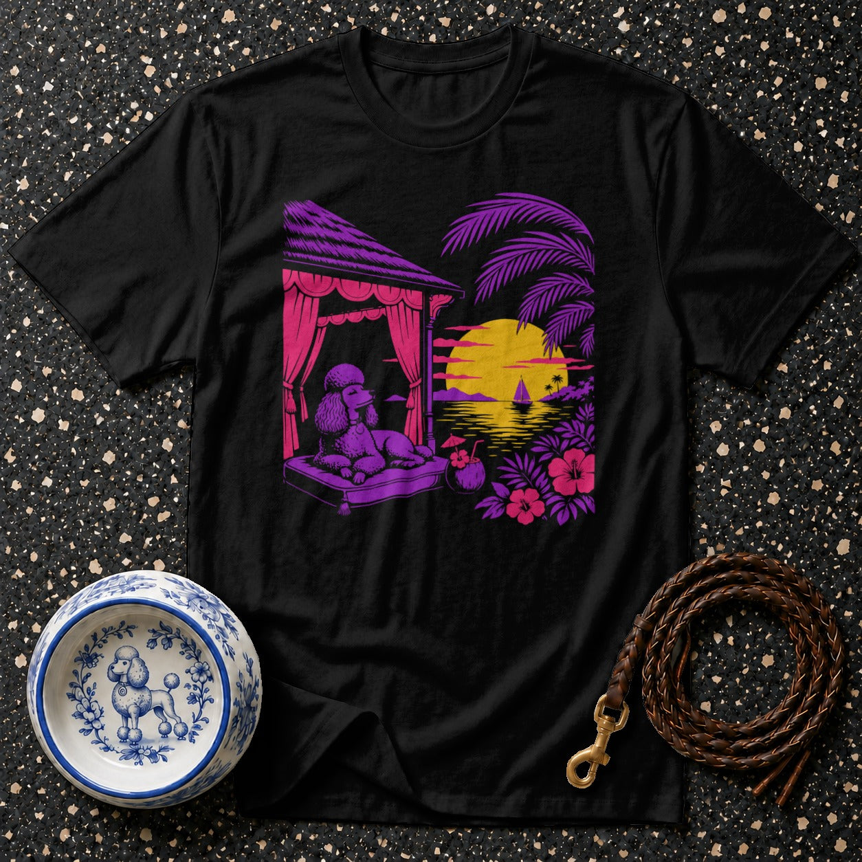 Black t-shirt with a poodle lounging on a cabana bed with a tropical sunset scene.