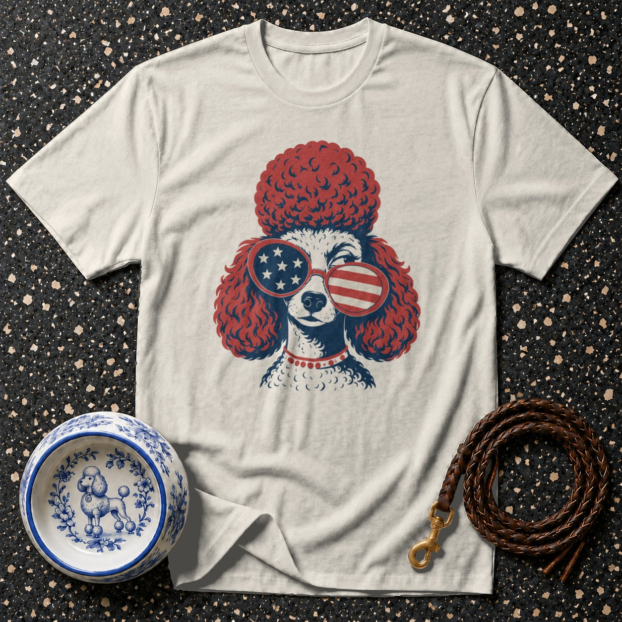 T-shirt featuring a poodle wearing American flag sunglasses and a red collar.