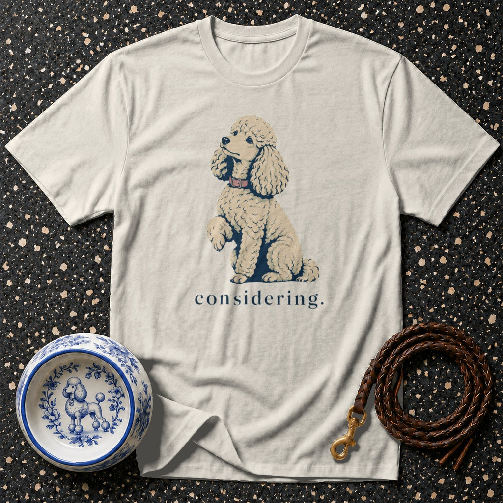 Light cream t-shirt with a poodle graphic and the word "considering".