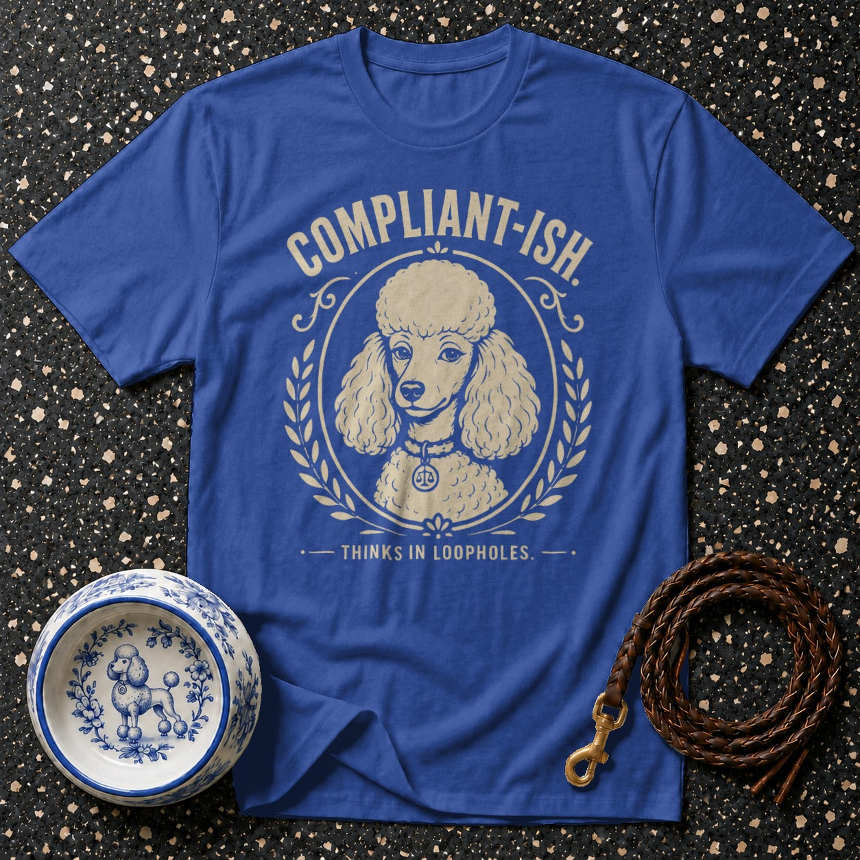 Blue t-shirt with a poodle graphic and text "Compliant-ish. Thinks in loopholes."