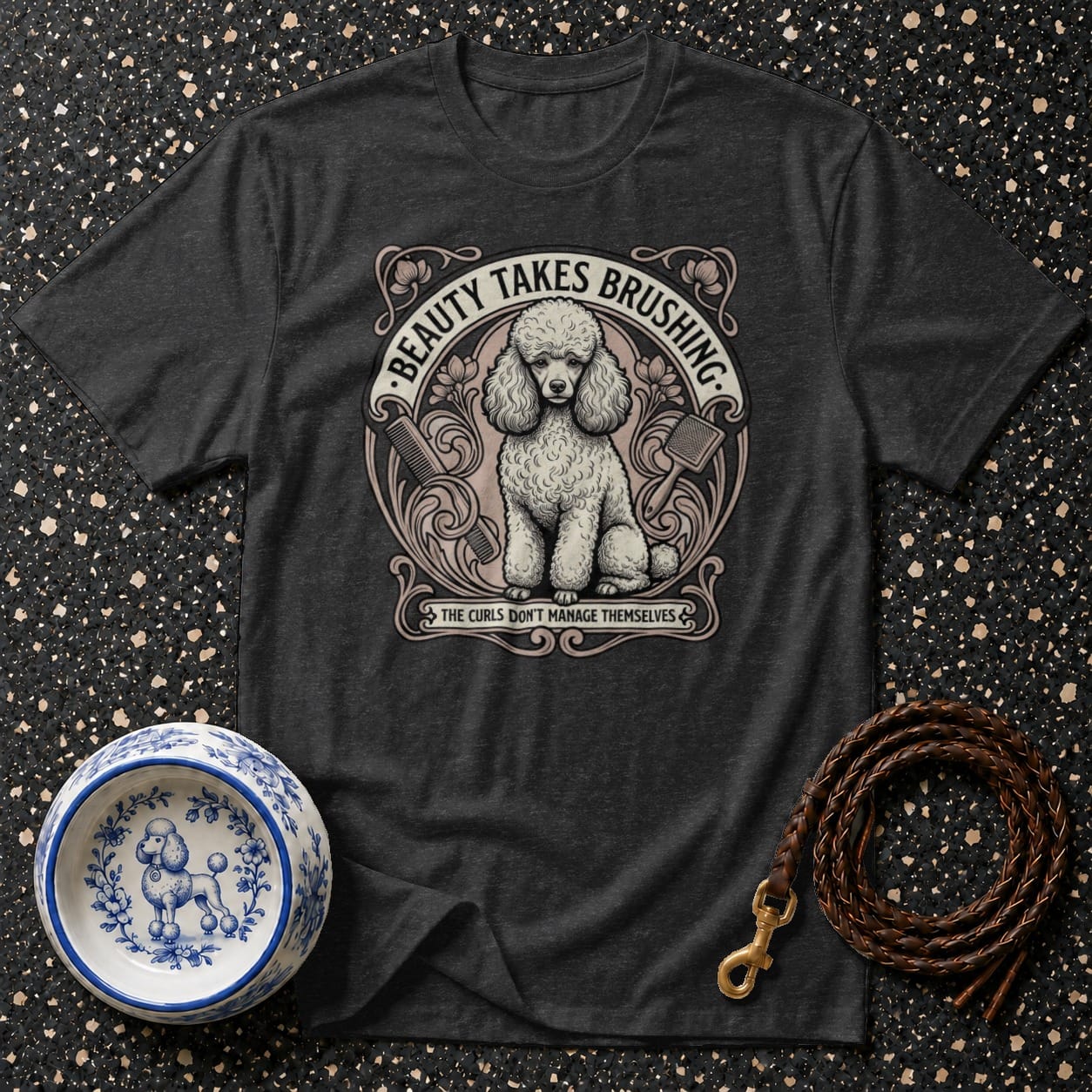 Dark t-shirt with a poodle illustration and text "BEAUTY TAKES BRUSHING."