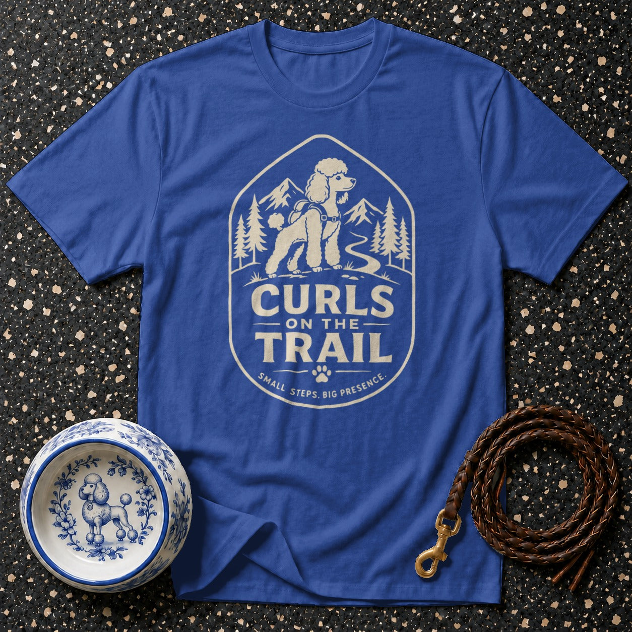 Blue t-shirt with poodle "Curls on the Trail" graphic and mountain scene.