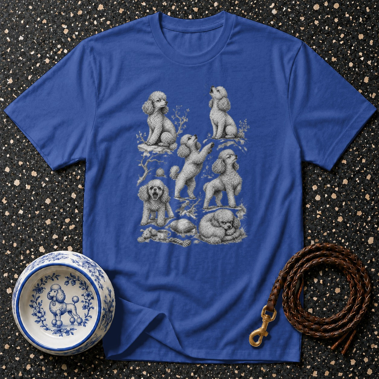 Blue t-shirt with a detailed drawing of poodles in various poses.
