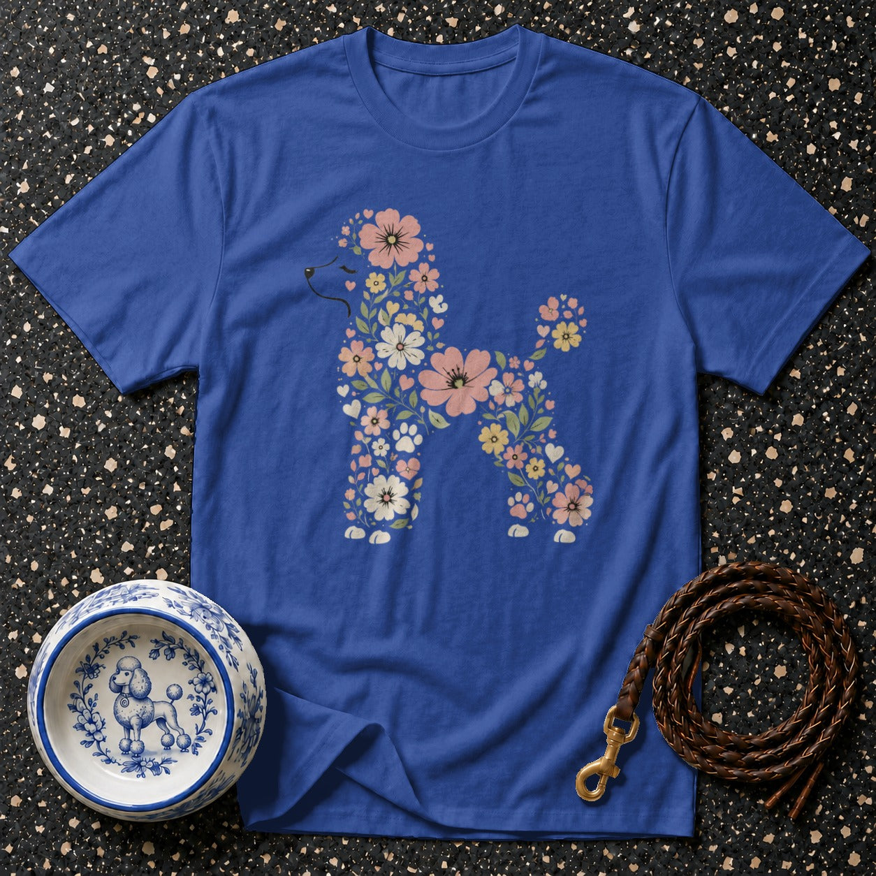 Blue t-shirt featuring a poodle silhouette made of pink, white, and yellow flowers.