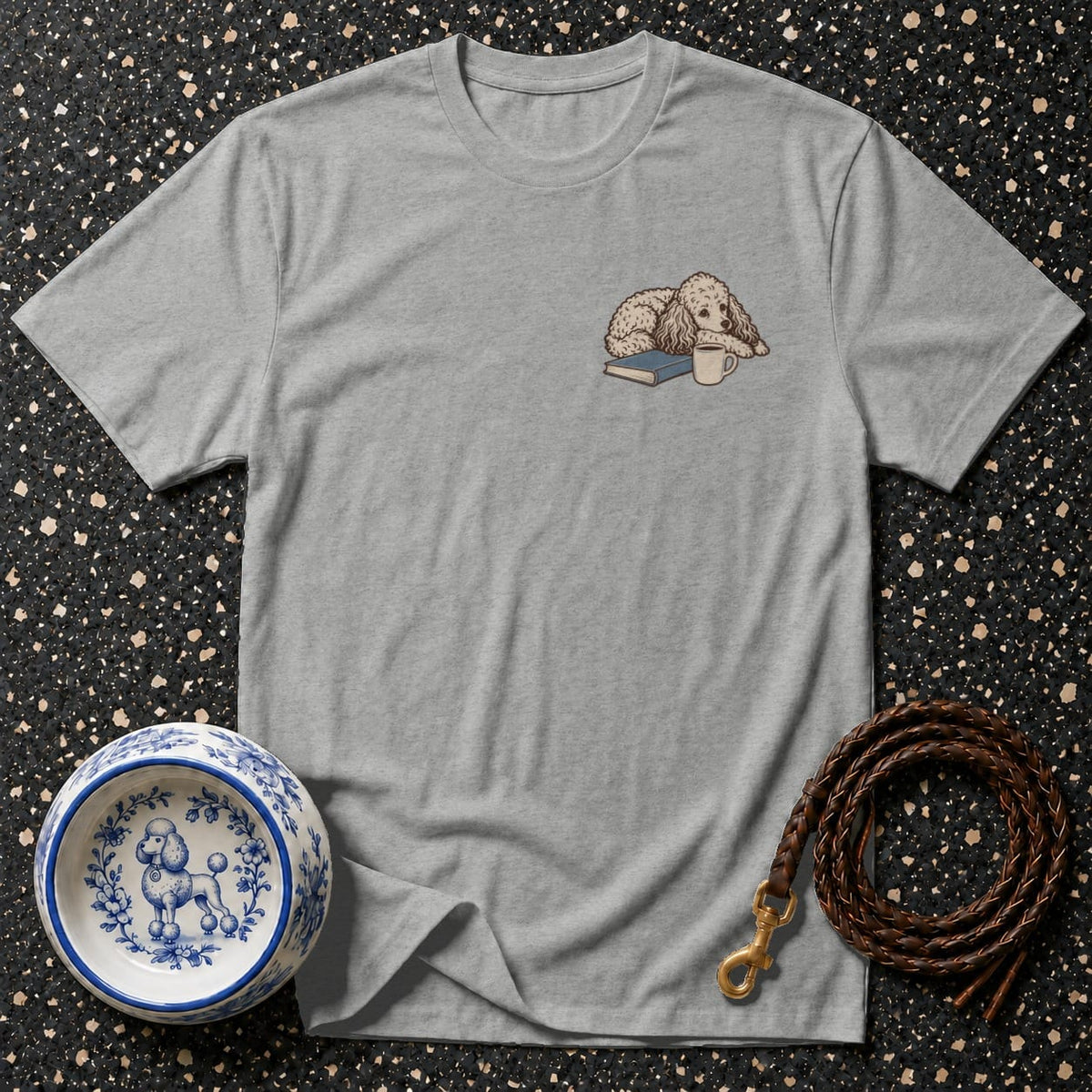 Grey t-shirt with embroidered poodle, book, and coffee cup on chest.