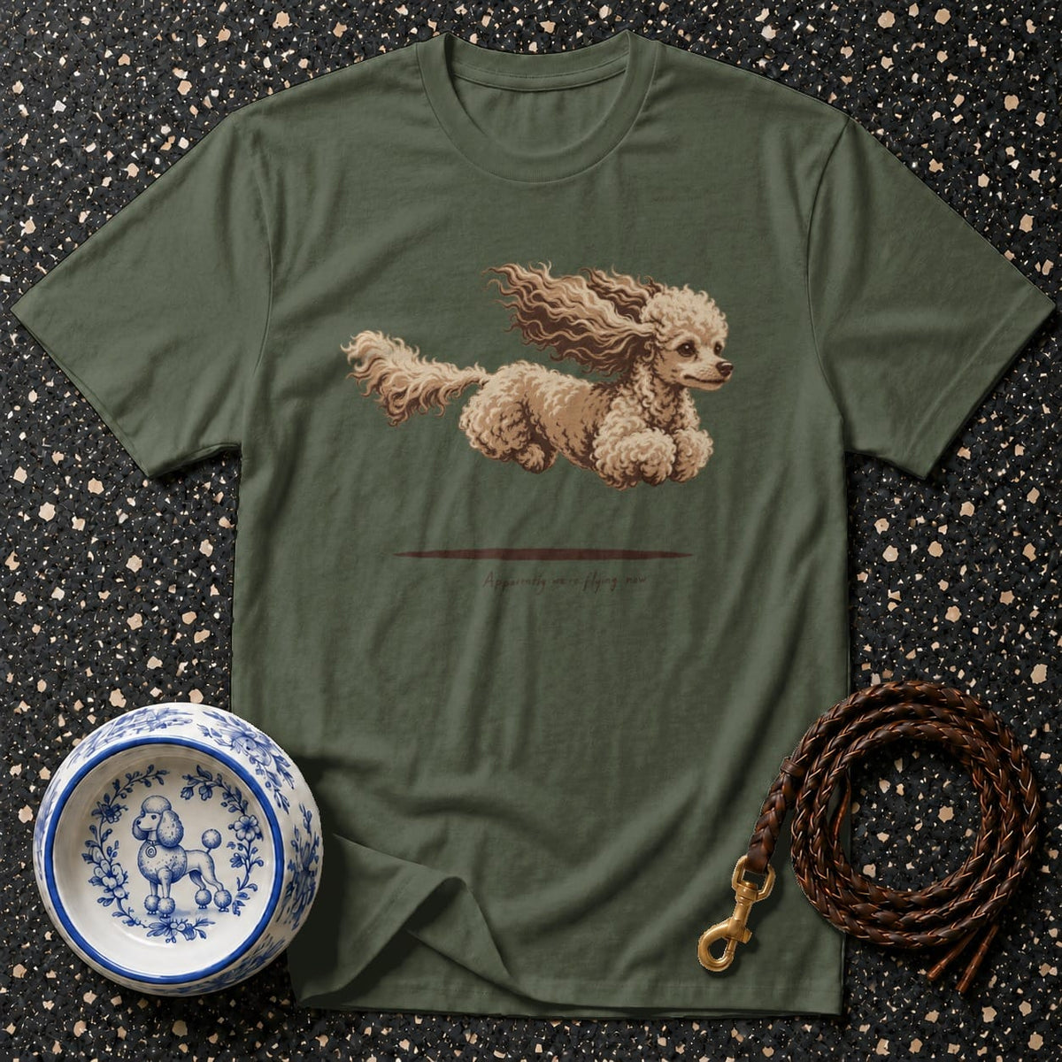 Olive green t-shirt with illustration of a poodle mid-air.