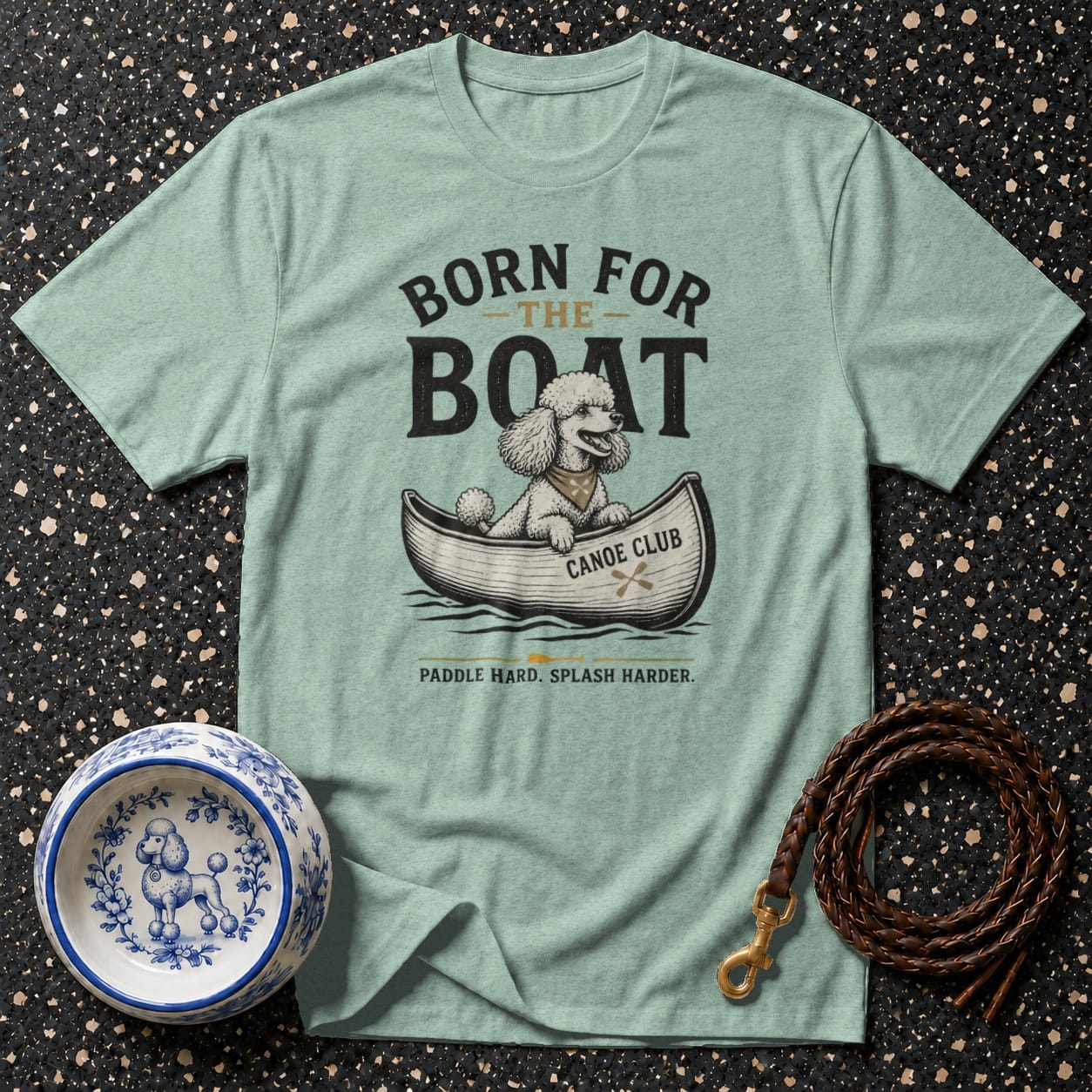 Light blue t-shirt with graphic of poodle in canoe, "Born for the Boat" text.