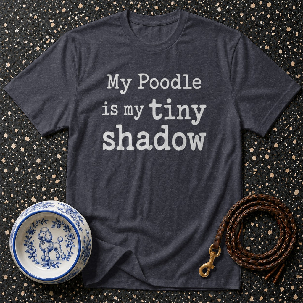 Dark t-shirt with white text "My Poodle is my tiny shadow", dog bowl, and leash.
