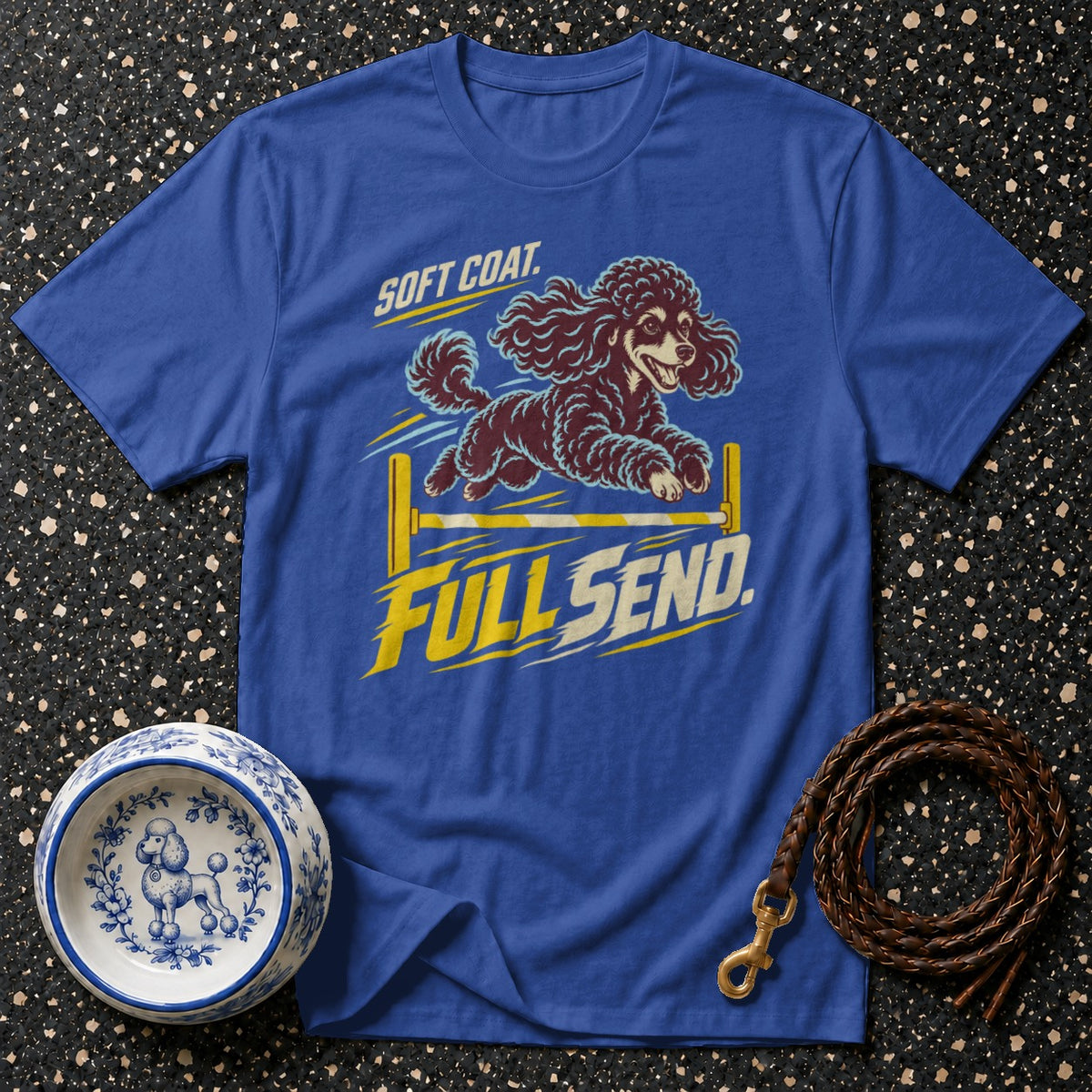 Blue t-shirt with graphic of a poodle jumping over a bar with "SOFT COAT. FULL SEND." text.