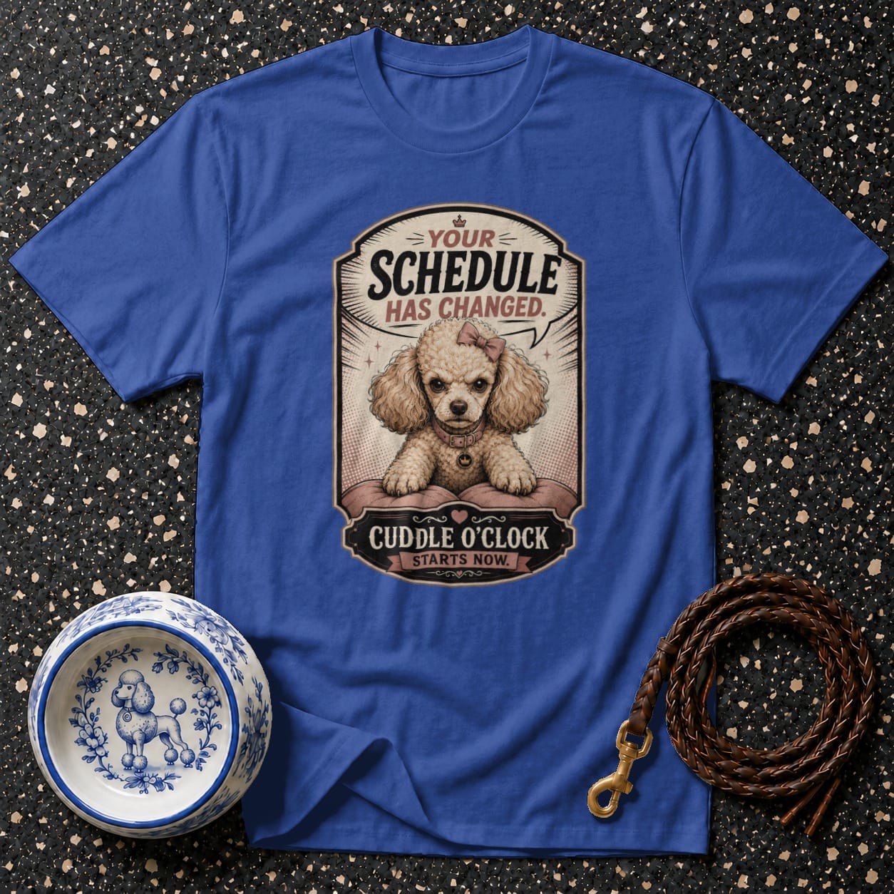 Blue t-shirt with a poodle graphic saying "Your schedule has changed. Cuddle o'clock starts now."