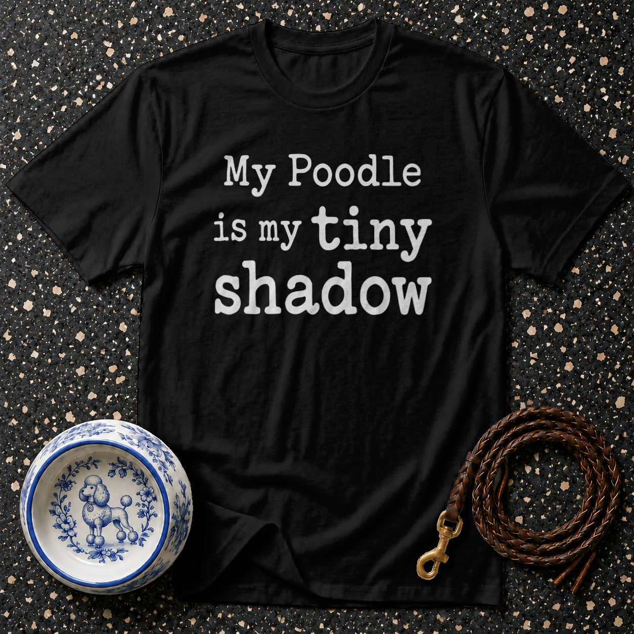 Black t-shirt with white text "My Poodle is my tiny shadow".