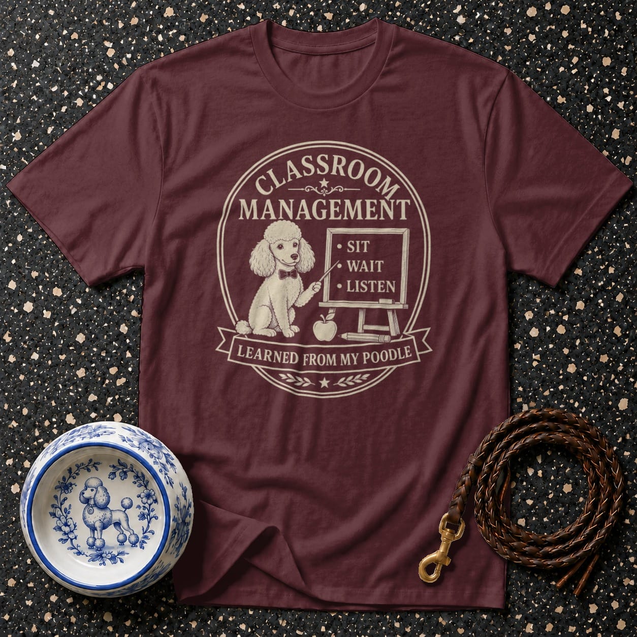 Maroon t-shirt with "Classroom Management Learned From My Poodle" graphic.