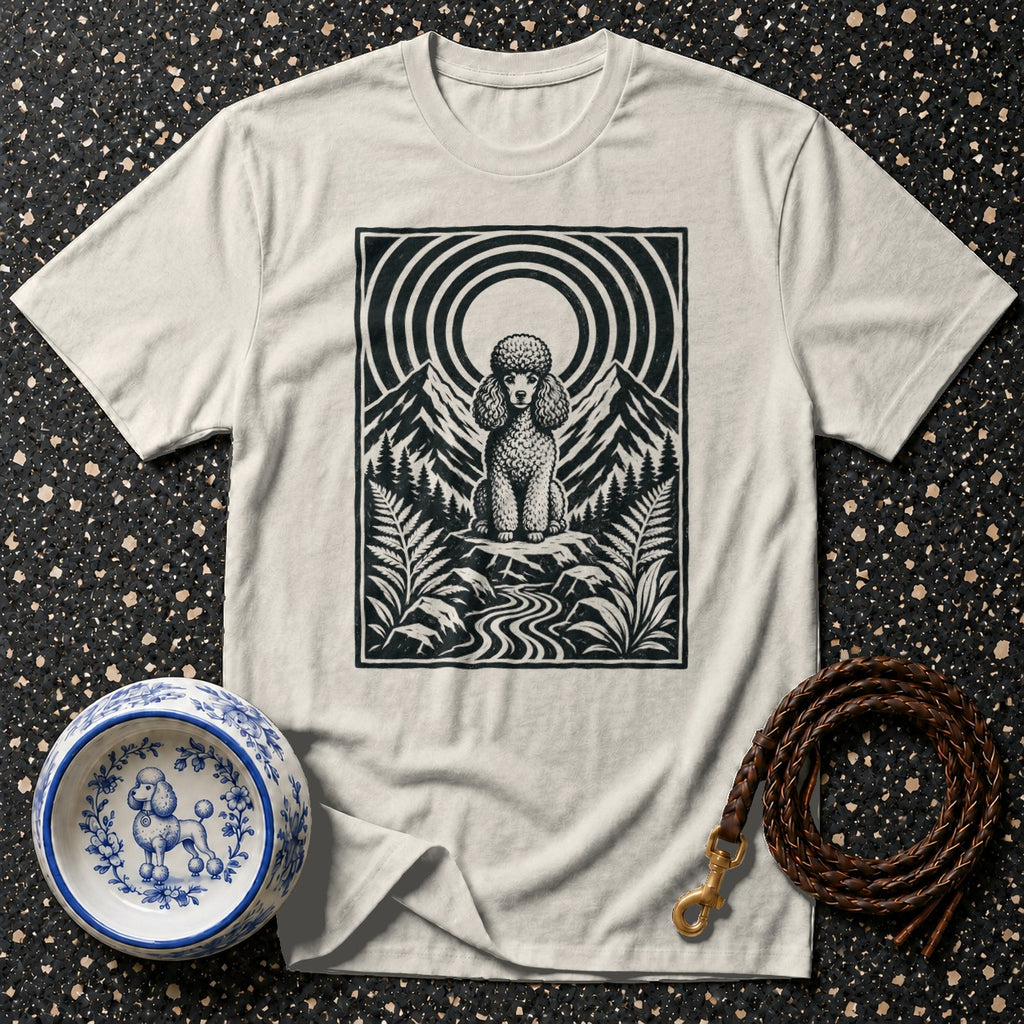 Cream t-shirt with black poodle illustration on mountain landscape.