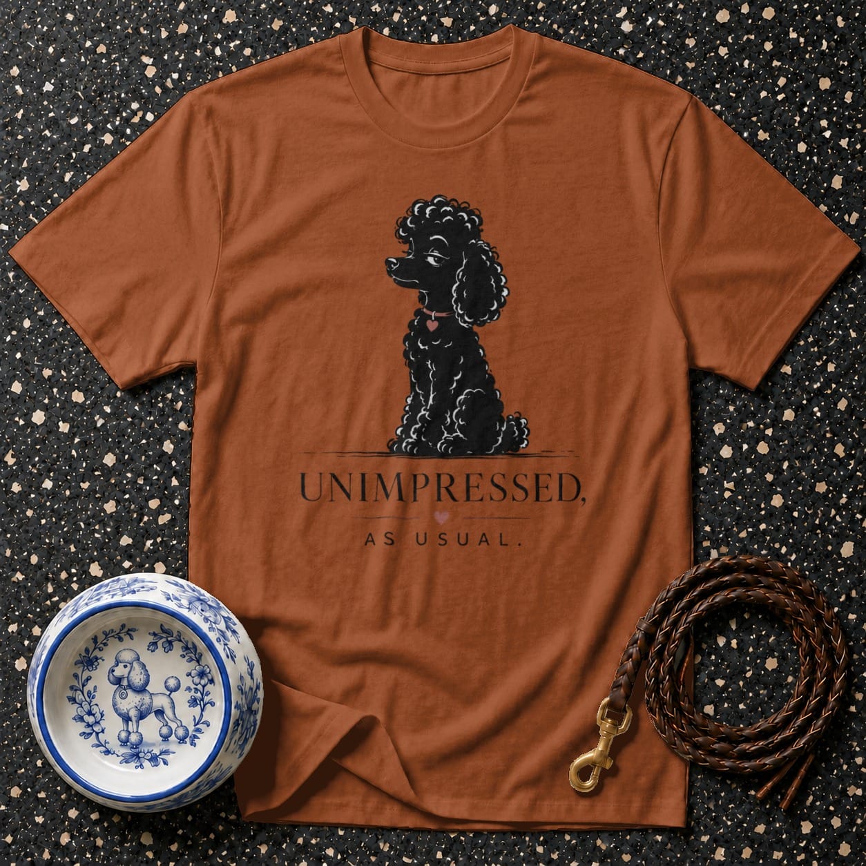T-shirt with black poodle graphic and text "UNIMPRESSED, AS USUAL."