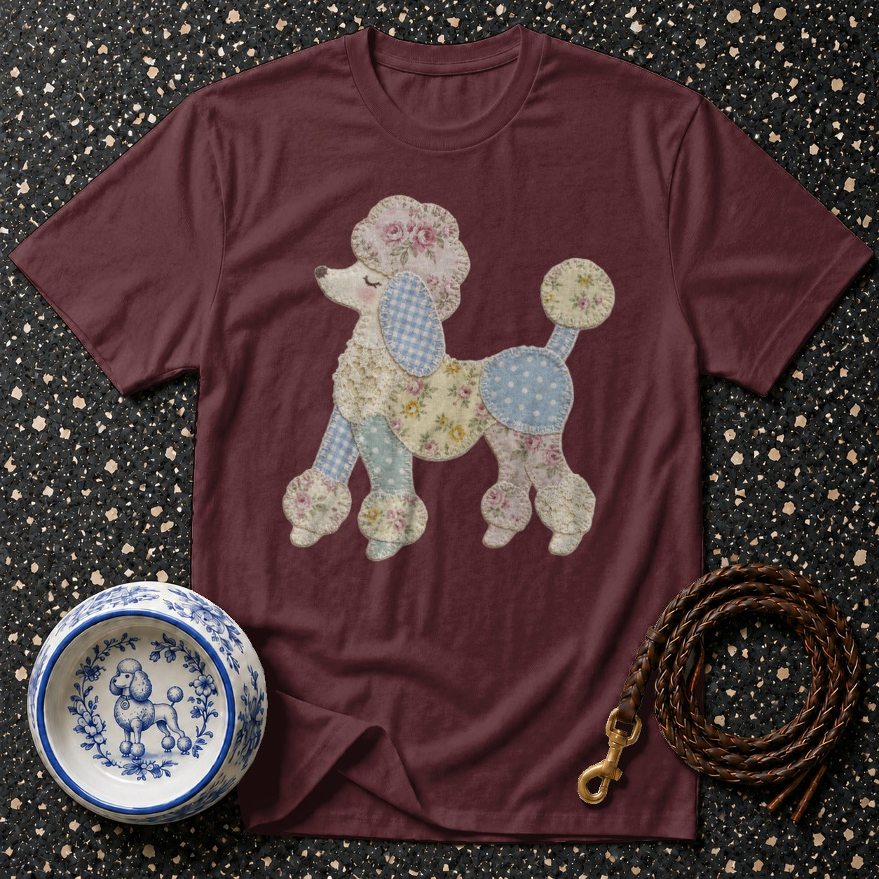Burgundy t-shirt with a patchwork poodle applique, dog bowl, and leather leash.