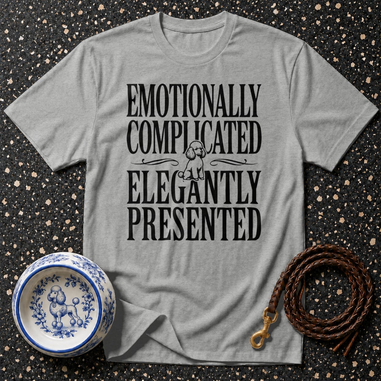 Grey t-shirt with text "EMOTIONALLY COMPLICATED ELEGANTLY PRESENTED" and a poodle graphic.