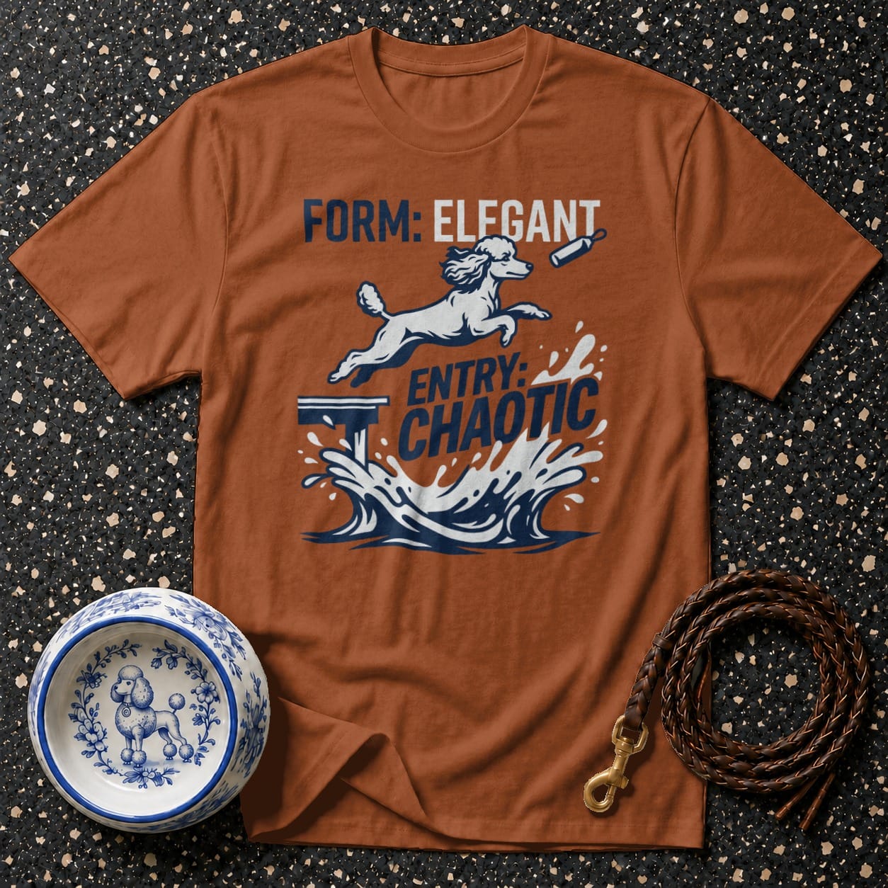 Brown t-shirt with a poodle jumping into water, text says "FORM: ELEGANT ENTRY: CHAOTIC".